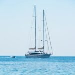 Elegant sailing yacht cruising on the calm blue waters under a clear sky.