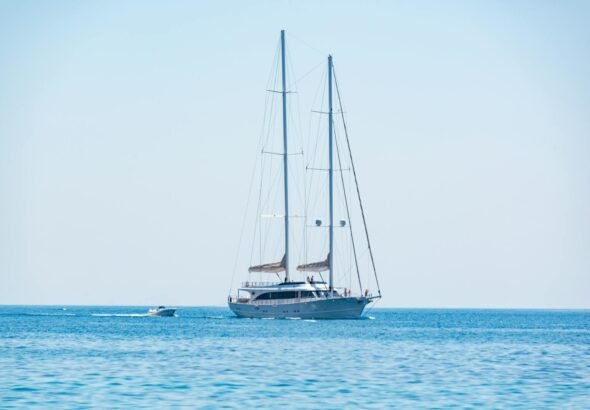 Elegant sailing yacht cruising on the calm blue waters under a clear sky.